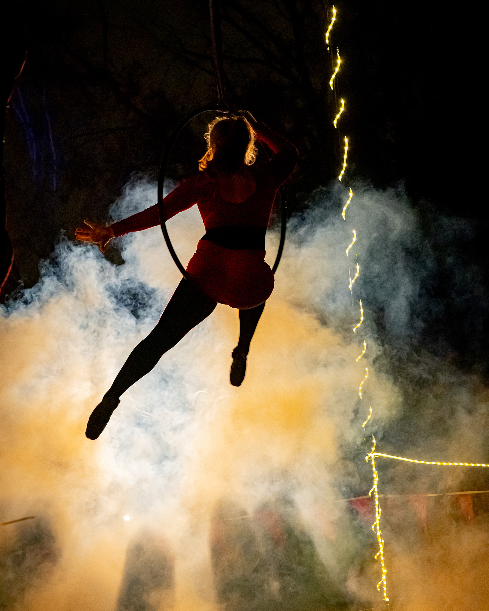 aerialist performs above a foggy ground